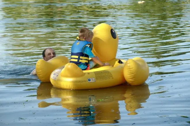A-child-on-an-inflatable-duck-in-a-pond