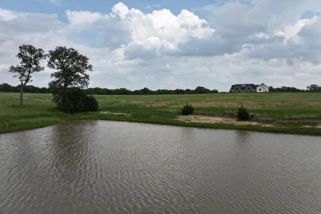 Lovely pond installation with a home visible in the background