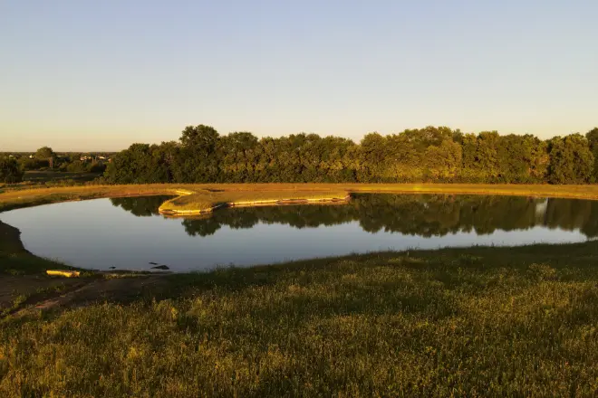 The answer to how much does it cost to build a pond depends a lot on the features, such as the peninsula seen in this pond