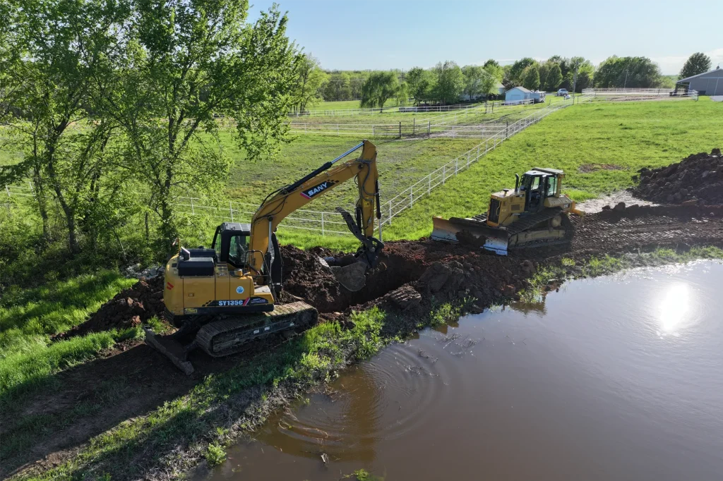 Excavator digging hole for the lake