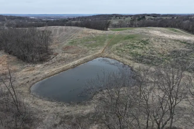A pond with an earthen dam that has a clay core trench