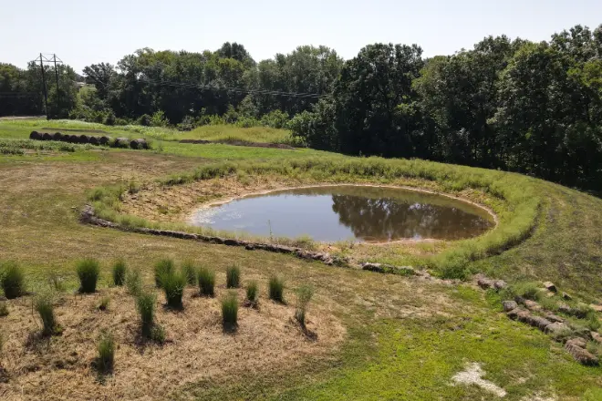 A pond in the process of being filled by natural rainwater.