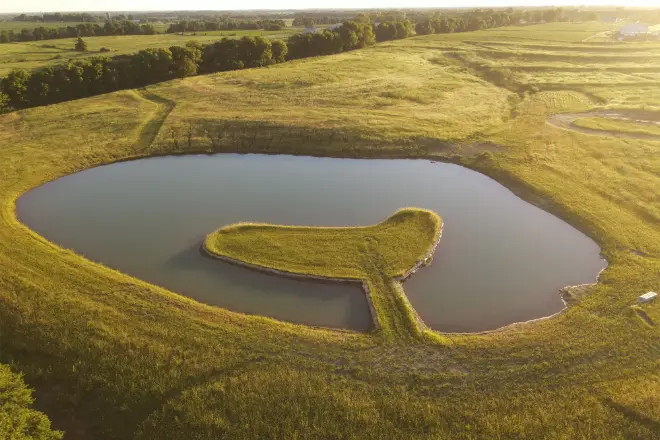 A pond with peninsula - landscaping ideas for large acreage pond