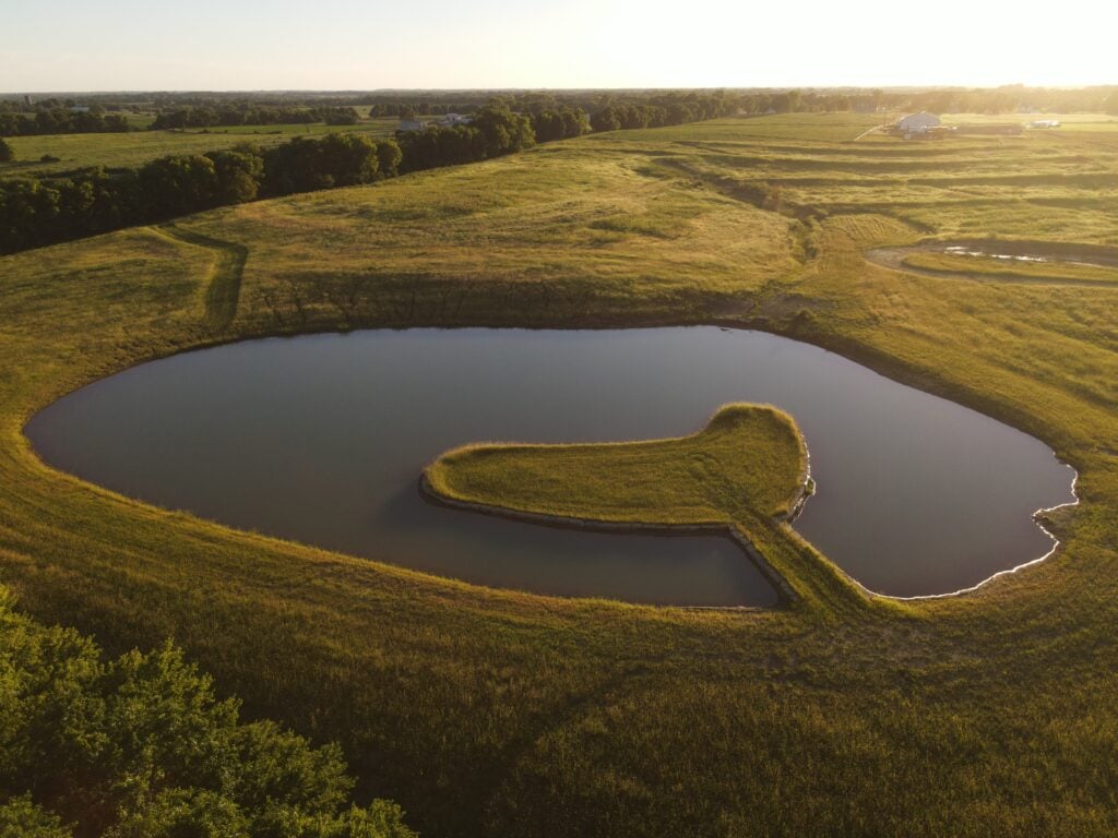 Upscale Waterfront New Pond Construction with Limestone Lined Peninsula, Designed and built by Bulletproof Pond and Lake in Gardner Kansas - Bulletproof Pond and Lake Upscale Waterfront New Pond Construction with Limestone Lined Peninsula, Designed and built by Bulletproof Pond and Lake in Gardner Kansas