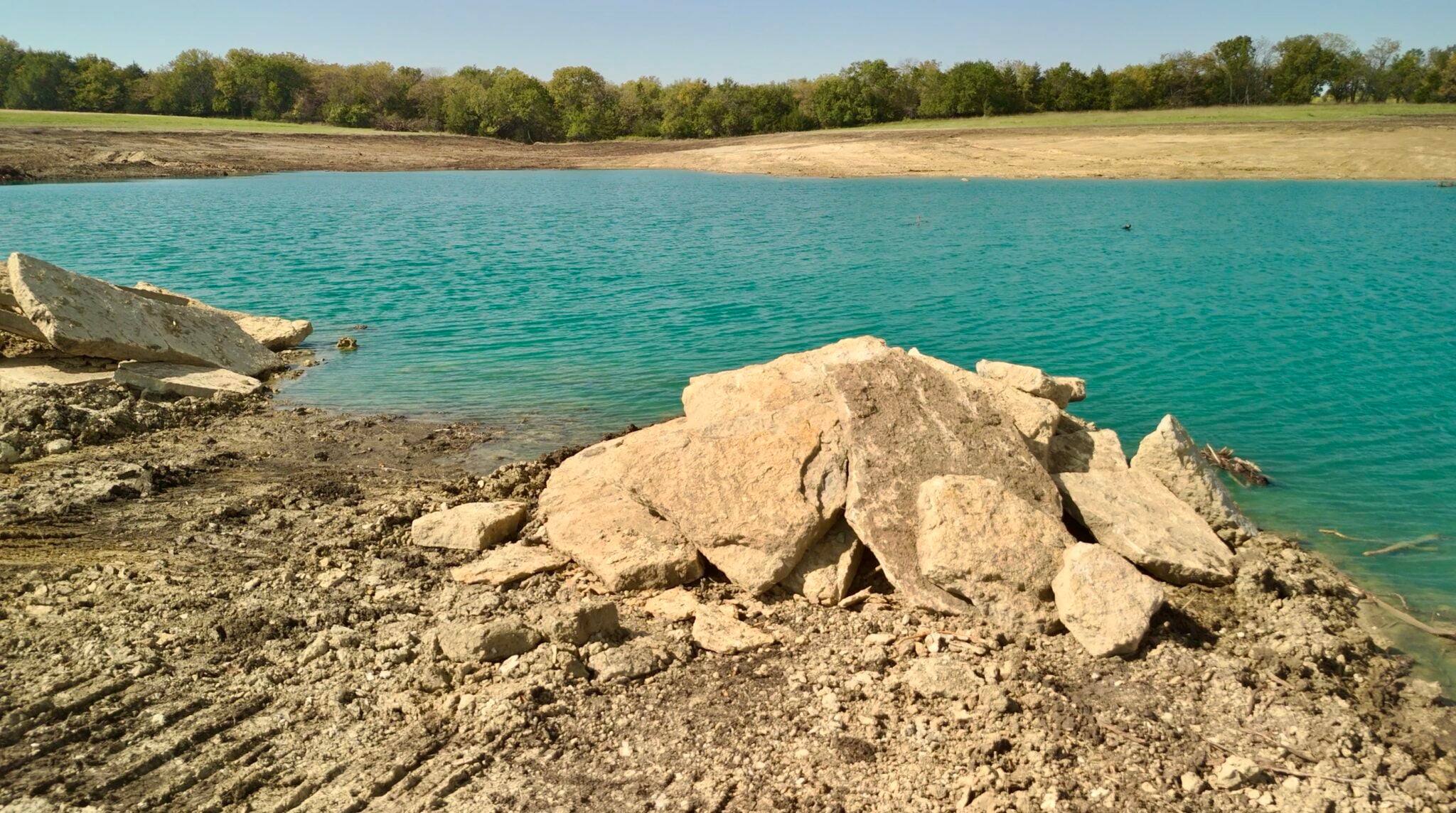 Natural rock fish habitat recycled from the property in a new lake in Melvern, Kansas by Bulletproof Pond and Lake